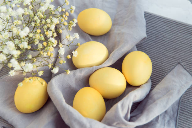 istock Yellow easter eggs with flowers on gray cloth 1333692092
