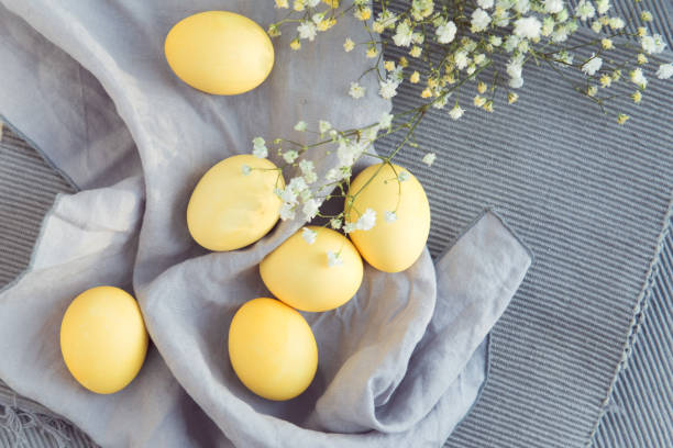 istock Yellow easter eggs with flowers on gray cloth 1333692094