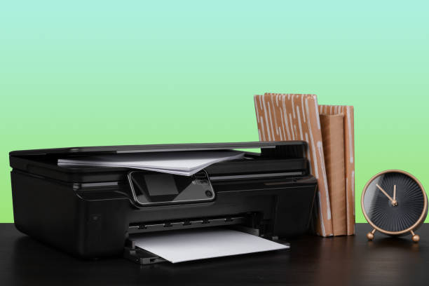 istock Home laser printer on desk against green background 1333693824