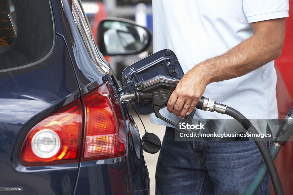 Man filling blue car with gasoline at gas station Detail Of Male Motorist Filling Car With Diesel At Petrol Station Gas Station Stock Photo