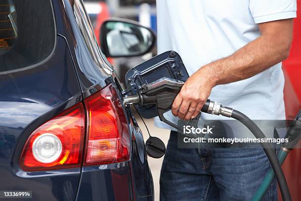 Man Filling Blue Car With Gasoline At Gas Station Stock Photo - Download Image Now - Gas Station, Refueling, Fuel Pump