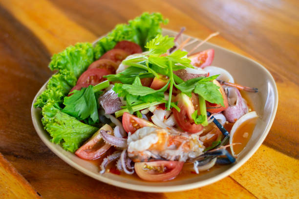 Spicy seafood salad Spicy seafood salad Or Yum Talay is a traditional Thai dish, using seafood to make a spicy salad. seafood salad stock pictures, royalty-free photos & images