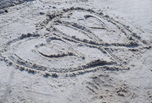 istock On the sand there is an image of two hearts. 1333703532