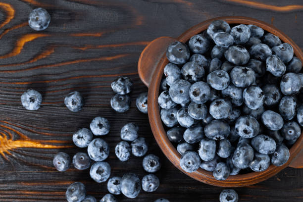 istock blueberries in a bowl on a wooden background. Top view 1333704268