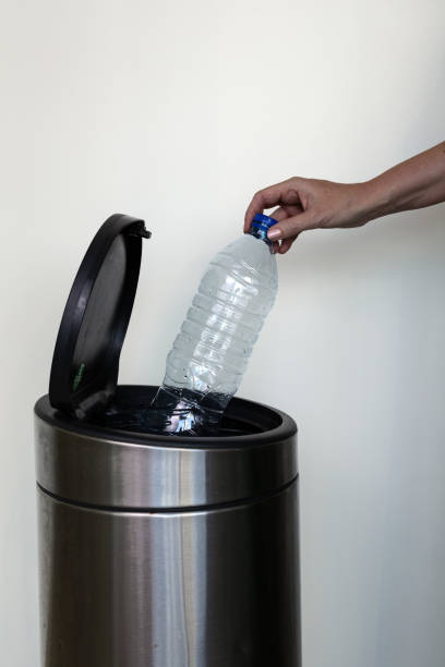 istock A woman's hand throwing out a plastic bottle in a rubbish bin 1333704578