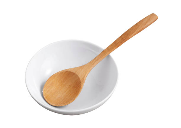 istock wooden spoon in ceramic cup isolated on white background 1333704613