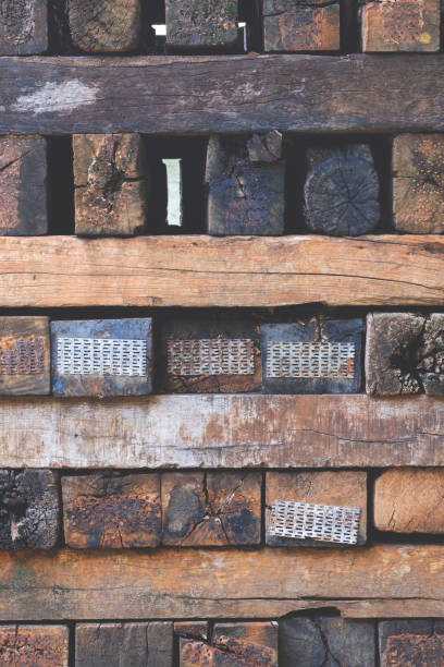 istock Stack of many old wooden sleepers or railroad ties in vertical frame 1333705835