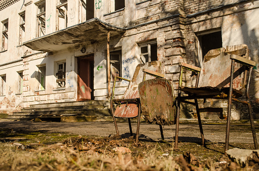 Abandoned military building and old chairs in Varve village, Latvia