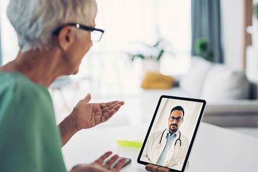 Senior woman having an online consultation with her doctor