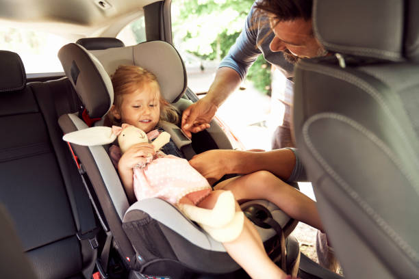istock Father fastening seat belt for daughter 1333711563
