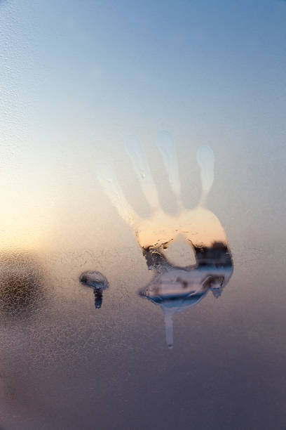 istock handprints on the glass frozen in winter 1333717841
