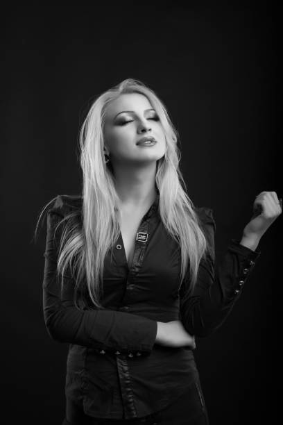 glamor blond lady with perfect makeup and long straight hair wears blouse, posing at studio. black and white sho - studio sho imagens e fotografias de stock