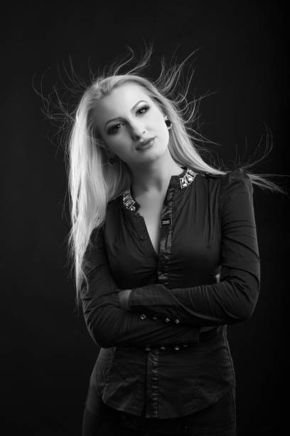 elegant blond lady with perfect makeup and long straight hair wears blouse, posing at studio. black and white sho - studio sho imagens e fotografias de stock