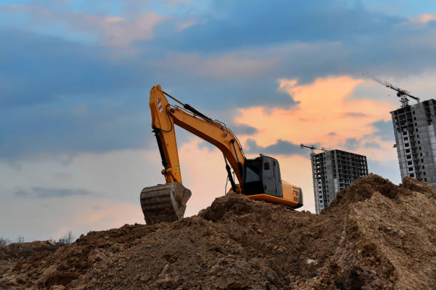 istock Excavator digging foundation at construction site. Heavy machinery for groungwork. House Construction Project Working. 1333723702