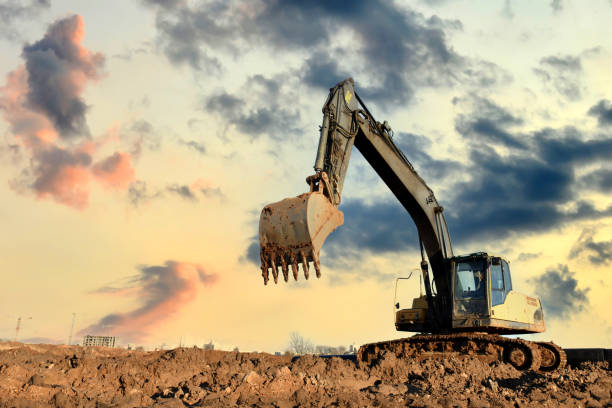 istock Excavator on earthworks at construction site on sunset background. 1333723853