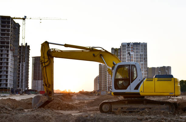 istock Excavator on earthworks at construction site on sunset background. 1333723916