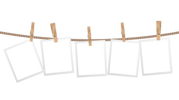 Realistic photo frames. Frame hanging on wooden clothespins on rope. Modern stylish decorative element for interior design, isolated scandinavian home accessory vector template Realistic photo frames. Frame hanging on wooden clothespins on rope. Modern stylish for interior design, isolated scandinavian home accessory vector template. Illustration blank empty photo picture clothespin stock illustrations