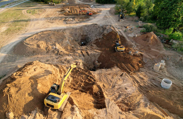 istock Excavator dig trench in ground at construction site. Foundation pit for a building. 1333728449