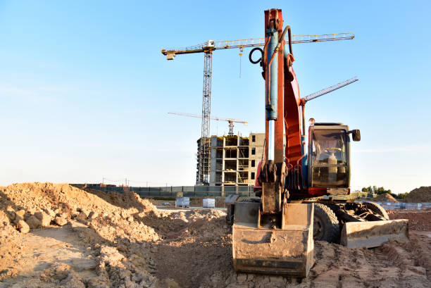istock Bucket wheel excavator on earthmoving at construction site. Backhoe earthworks. Earthmoving heavy equipment for construction. Tower crane during the construction of a skyscraper. Building industry 1333728979
