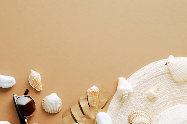 istock Straw beach hat, golden monstera leaf, sunglasses on sandy background. Summer flat lay composition. 1333729925