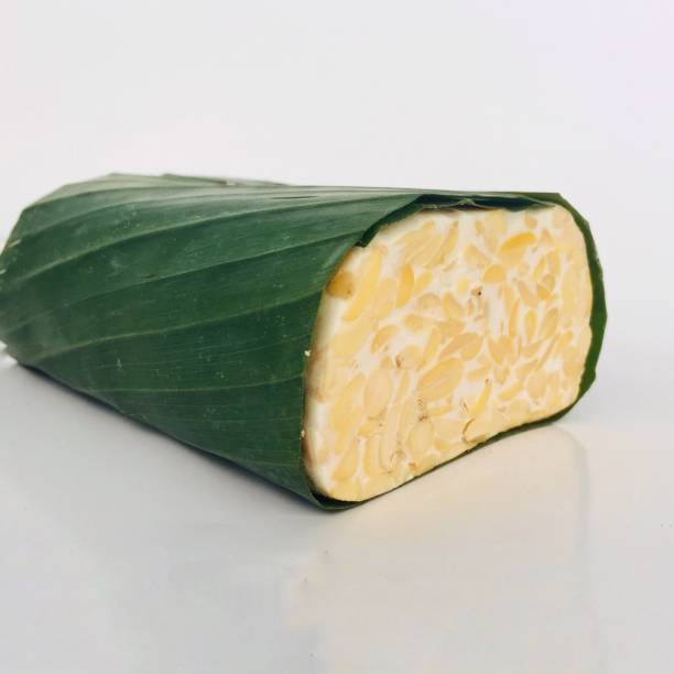 istock Raw tempeh wrapped in banana leaves. 1333730030