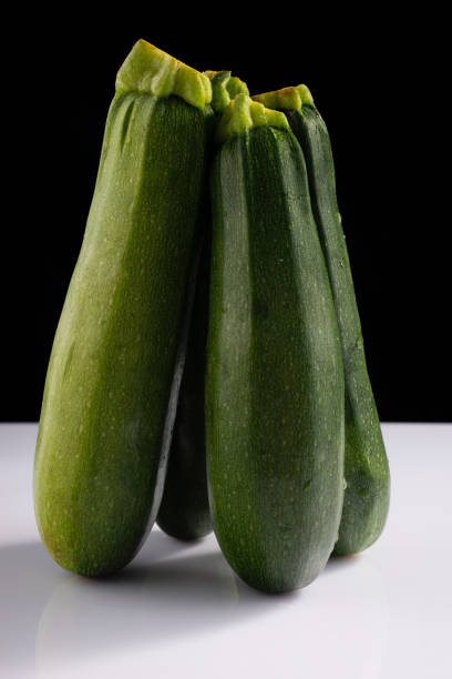 istock zucchini zucchini on black and white background. Minimalistic concept 1333730714