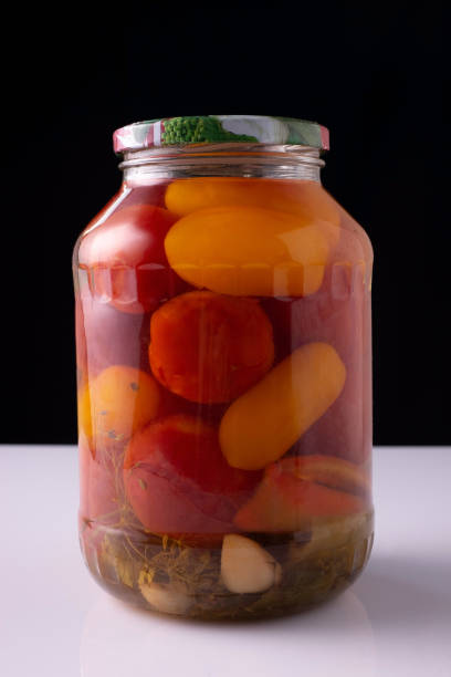 istock canned vegetables in a jar on a white table and black background 1333731104