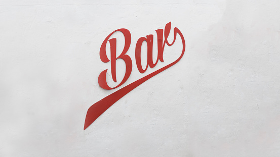 White painted wall with the word bar written in red