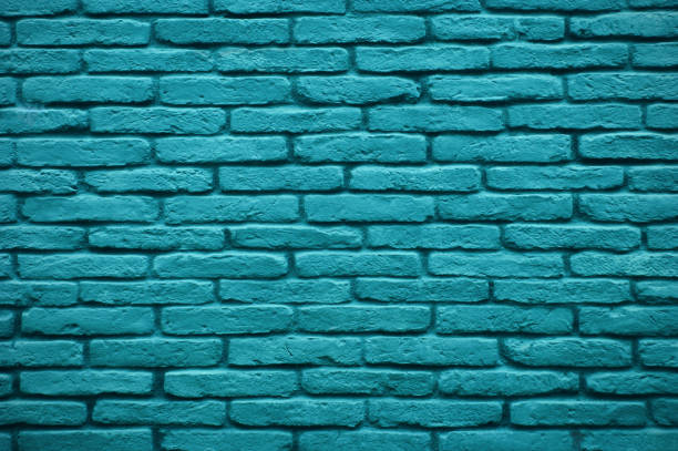 istock Commercial building brick wall painted green, textured background. 1333732088