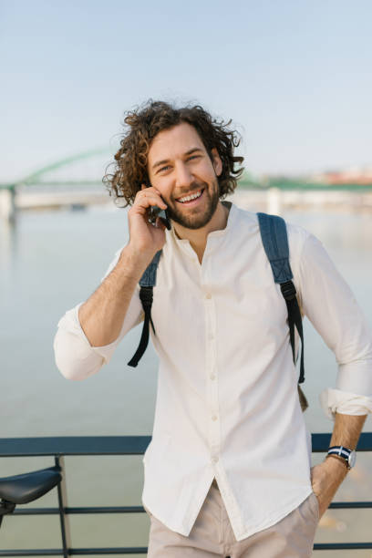 istock Cheerful young manager looking at camera and talking on the phone 1333734739