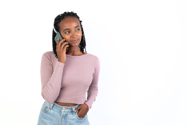 Beautiful woman talking on the phone. White background. African-Ethiopian black woman.