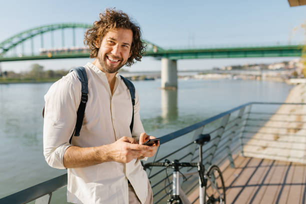 istock Cheerful young businessman laughing while using his phone 1333736400
