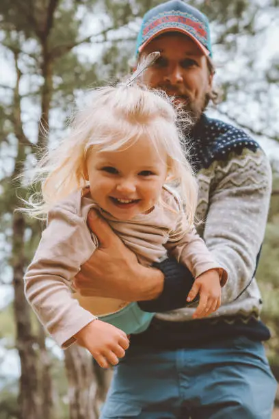 Photo of Child girl playing with father outdoor happy family smiling daughter and dad traveling together summer vacations lifestyle