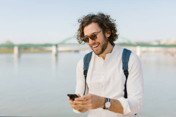 istock Cheerful young businessman scrolling through his phone and laughing 1333737389