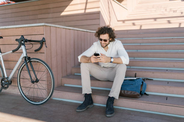 istock Handsome young manager text messaging on the bridge stairs 1333738183