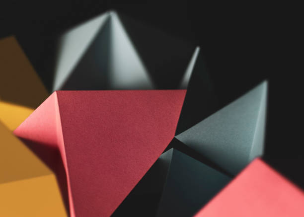 Geometric shapes made colorful paper, dark background