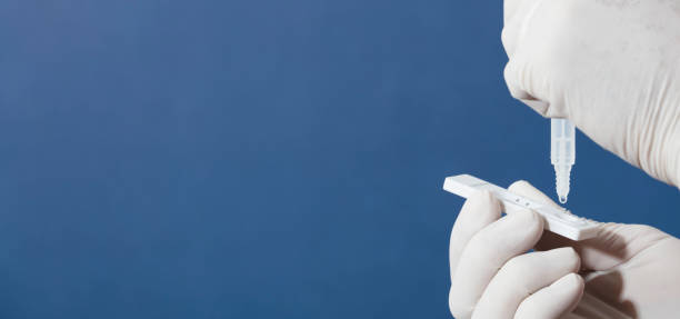 istock nurse or doctor performs antigen test, with blue background 1333739485