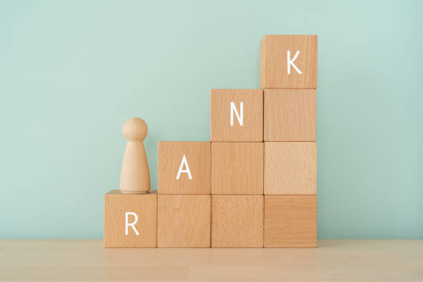 rank; wooden blocks with "rank" text of concept and a human toy. - rank imagens e fotografias de stock