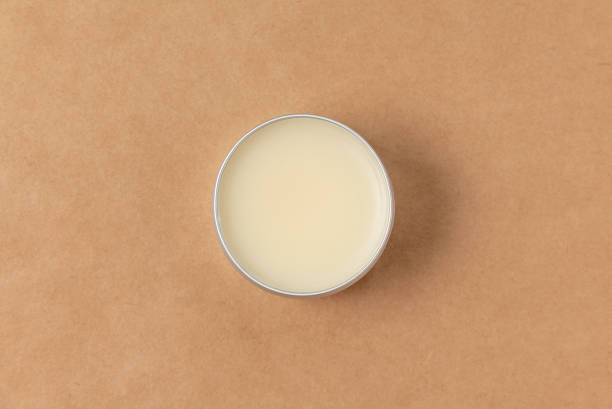 open small jar with wax for processing and caring for genuine leather products Open small tube of wax for processing genuine leather top view. Jar of Vaseline leather care stock pictures, royalty-free photos & images
