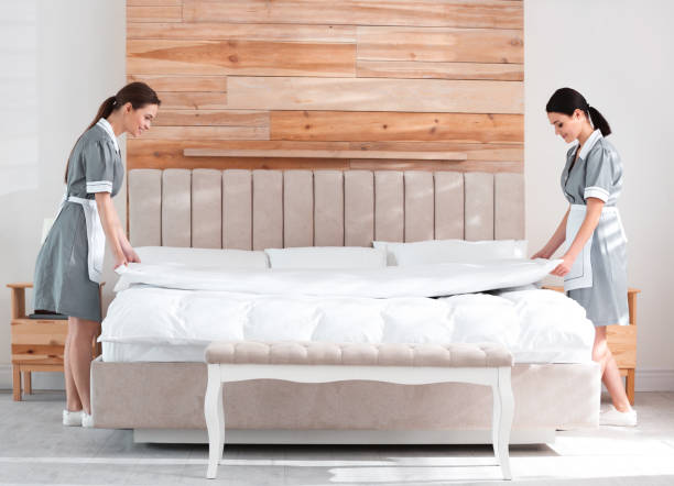 istock Young chambermaids making bed in hotel room 1333741147