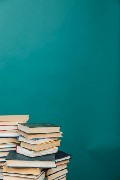 istock Stacks of books for teaching knowledge college library green background 1333741336