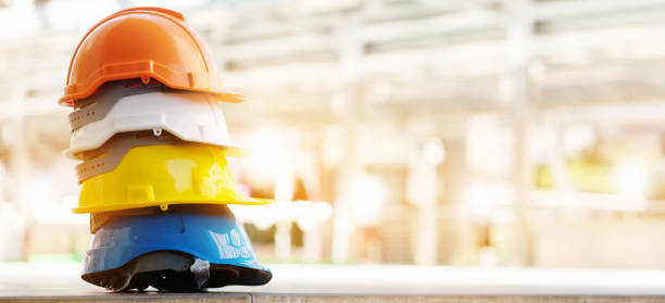istock Safety Construction Worker Hats Blue, white, yellow, orange. Teamwork of construction team must have quality. Whether it engineer, construction workers. Have a helmet to wear at work. Safety at work. 1333743897