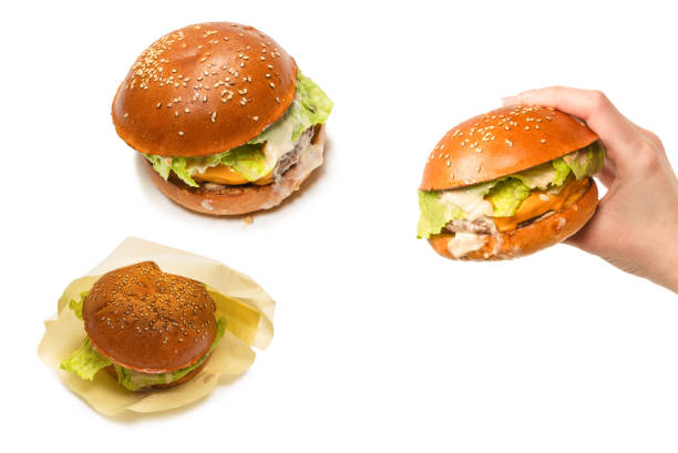 istock Hamburger in woman hands isolated on a white background. 1333746086