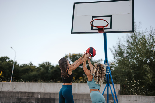 Young female basketball players playing a game on a sports court