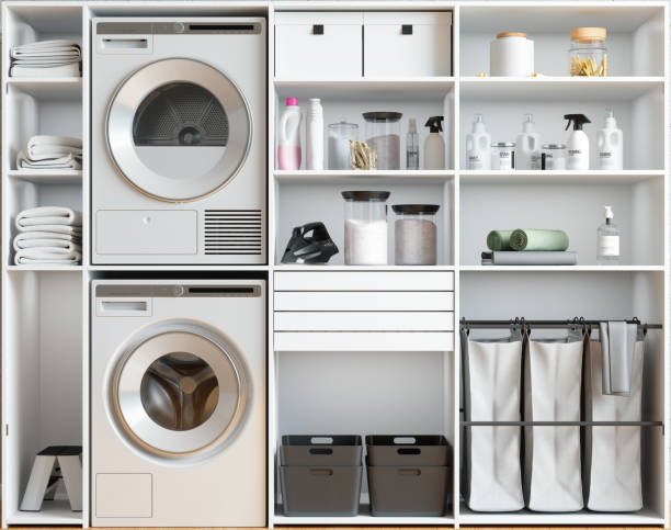 Washing Machine, Dryer, Laundry Basket, Folded Towels And Laundry Detergent In White Cabinet. Washing Machine, Dryer, Laundry Basket, Folded Towels And Laundry Detergent In White Cabinet. laundromat laundry residential structure cleaning stock pictures, royalty-free photos & images