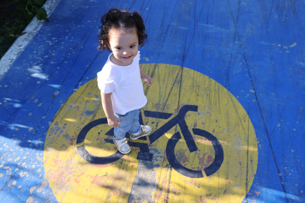 Girl playing on bicycle lane