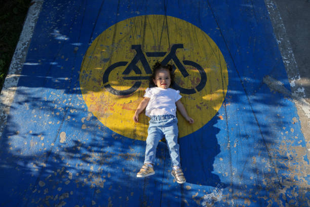 Girl playing on bicycle lane