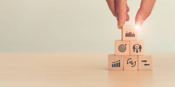 istock Benchmarking concept. Comparing business processes and performance. Man hold wooden cubes  performance, process, compare and target icon isolated on white background and copy space. Used for banner. 1333750937