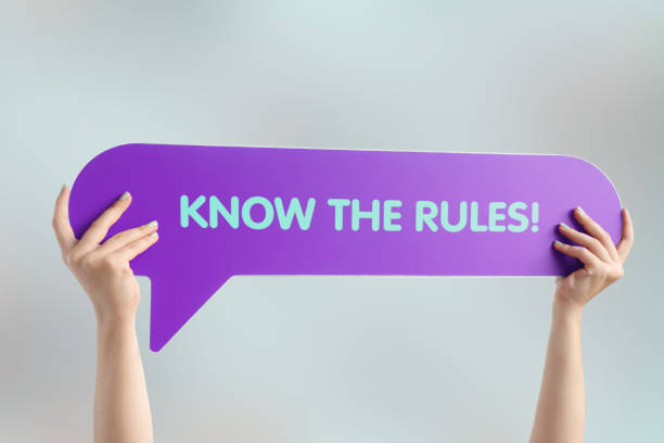 Know the rules! Hand holding speech bubble with know the rules word rules quotes stock pictures, royalty-free photos & images