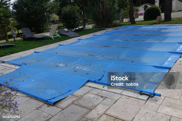 Outdoor Swimming Pool Covered Due To Bad Weather Summer Season Holiday Resort Stock Photo - Download Image Now